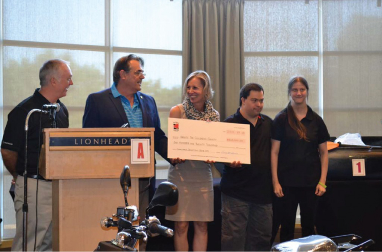 Joint Council 52 President Craig McInnes presents Variety CEO Karen Stintz a $120,000 cheque.